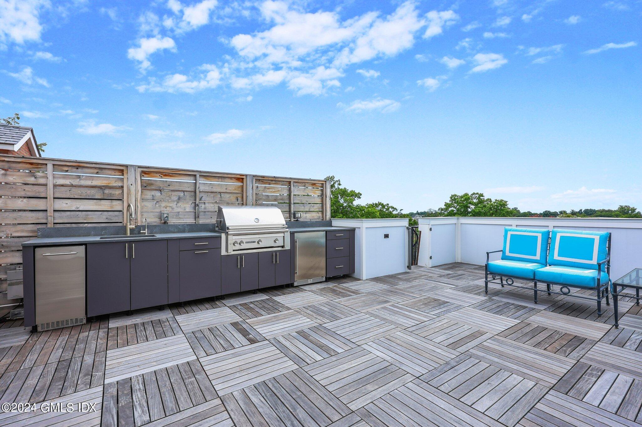 62 Mason Street, Unit PHW Greenwich, CT 06830 - Photo 17 of 18 a view of a terrace with a bench