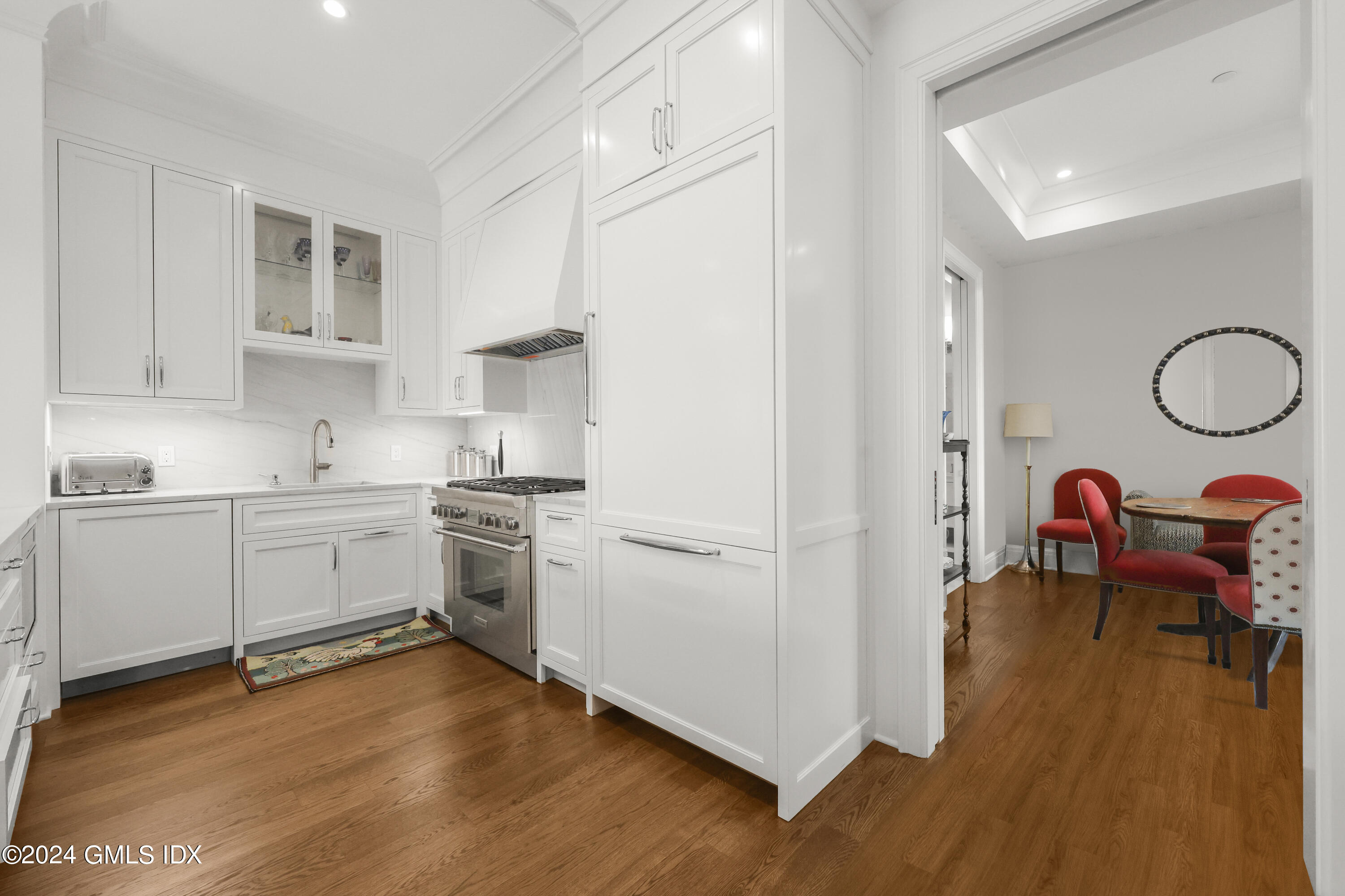 62 Mason Street, Unit PHW Greenwich, CT 06830 - Photo 8 of 18 a kitchen with a refrigerator and white cabinets