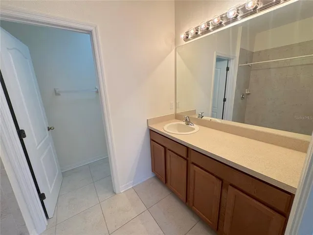 a bathroom with a sink a mirror and a shower