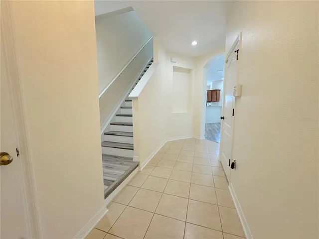 a view of hallway with stairs and a window