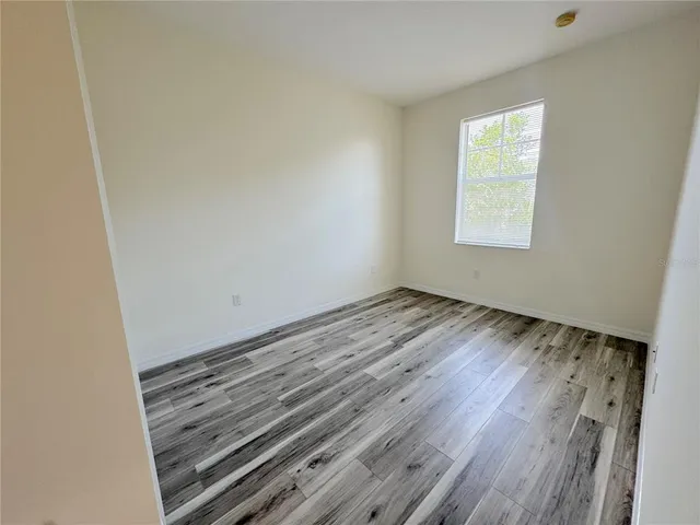 an empty room with wooden floor