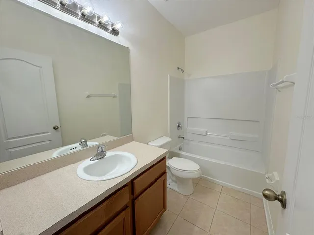 a bathroom with a sink toilet tub and shower