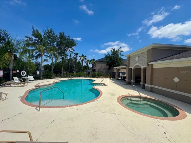 a view of a swimming pool with a patio
