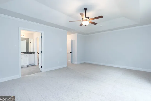 an empty room with closet and a chandelier fan