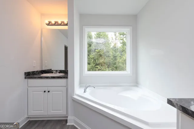 a bathroom with a bathtub and a window