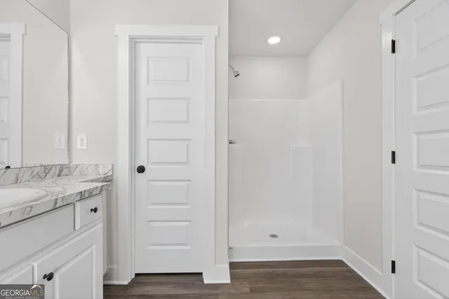 a view of a house with a big yard and large trees