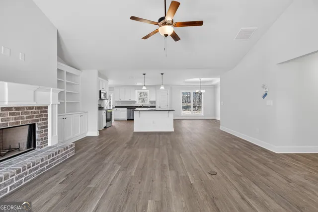 a view of a kitchen with wooden floor and a kitchen