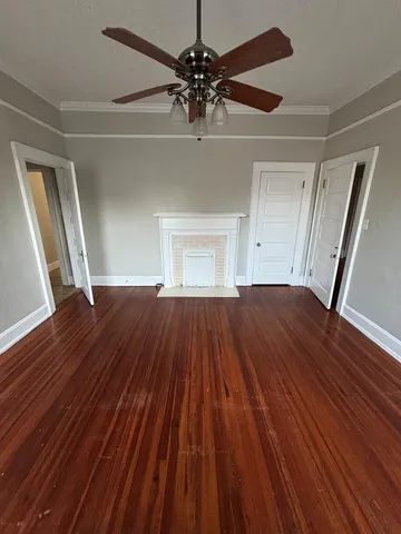 a view of walk in closet with wooden floor and stairs