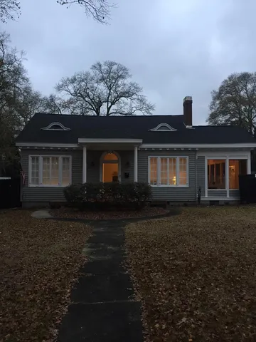 a front view of a house with a garden