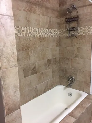 a view of a hallway with wooden floor and windows
