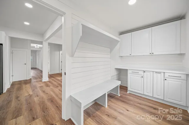 a view of kitchen with wooden floor and electronic appliances