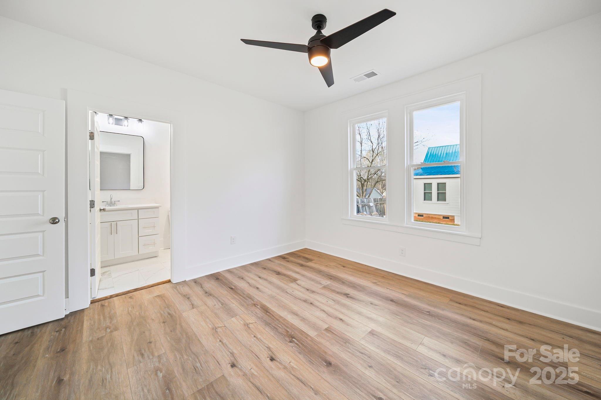 1703 Lowder Street Albemarle, NC 28001 - Photo 16 of 31 a view of empty room with wooden floor and fan