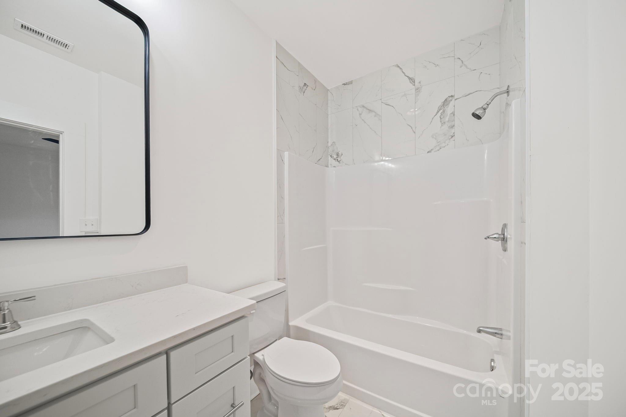 1703 Lowder Street Albemarle, NC 28001 - Photo 18 of 31 a bathroom with a sink a toilet and shower