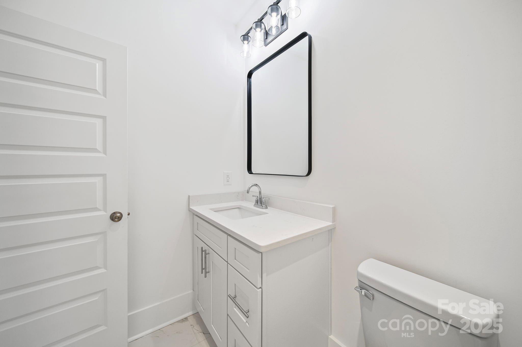 1703 Lowder Street Albemarle, NC 28001 - Photo 19 of 31 a bathroom with a sink and a mirror