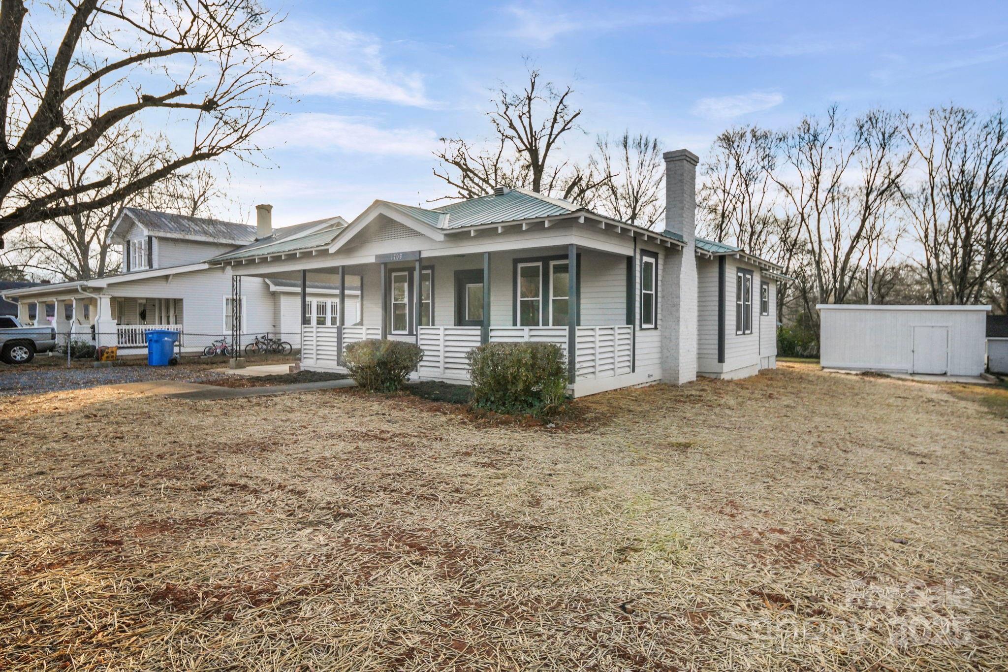 1703 Lowder Street Albemarle, NC 28001 - Photo 2 of 31 a front view of a house with a garden and trees