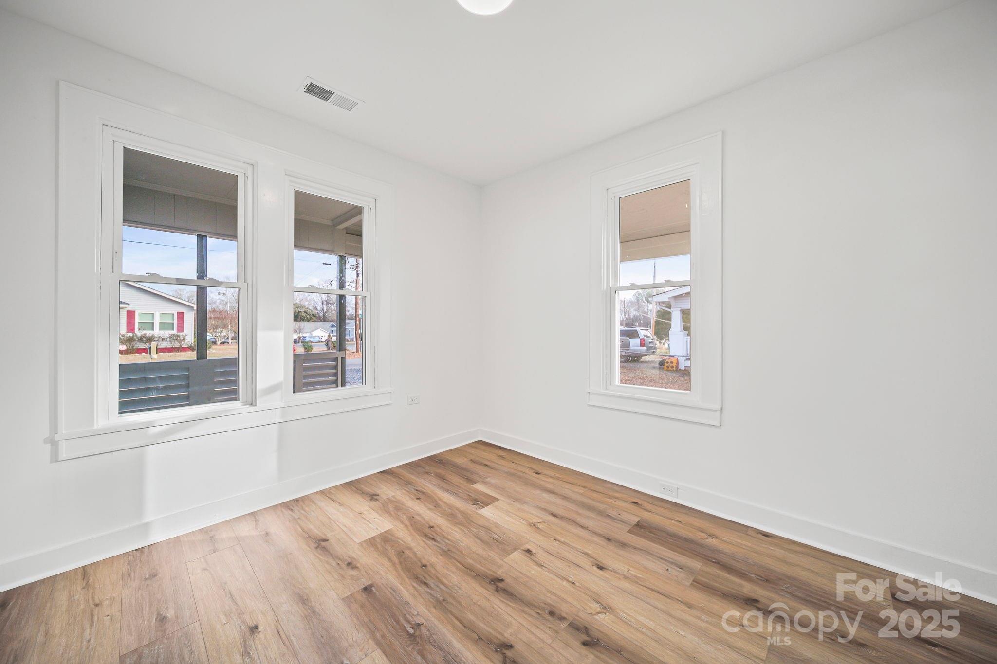 1703 Lowder Street Albemarle, NC 28001 - Photo 21 of 31 an empty room with wooden floor and windows