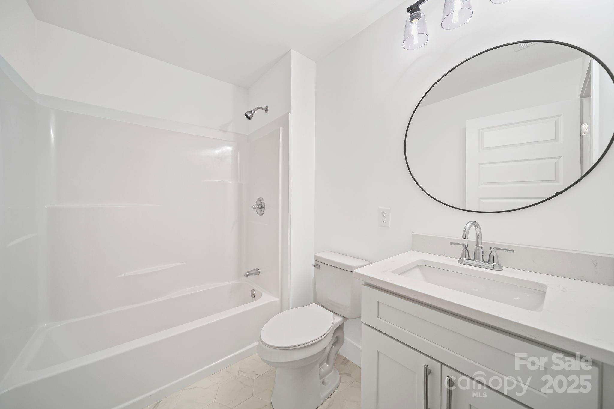 1703 Lowder Street Albemarle, NC 28001 - Photo 22 of 31 a bathroom with a sink toilet and shower