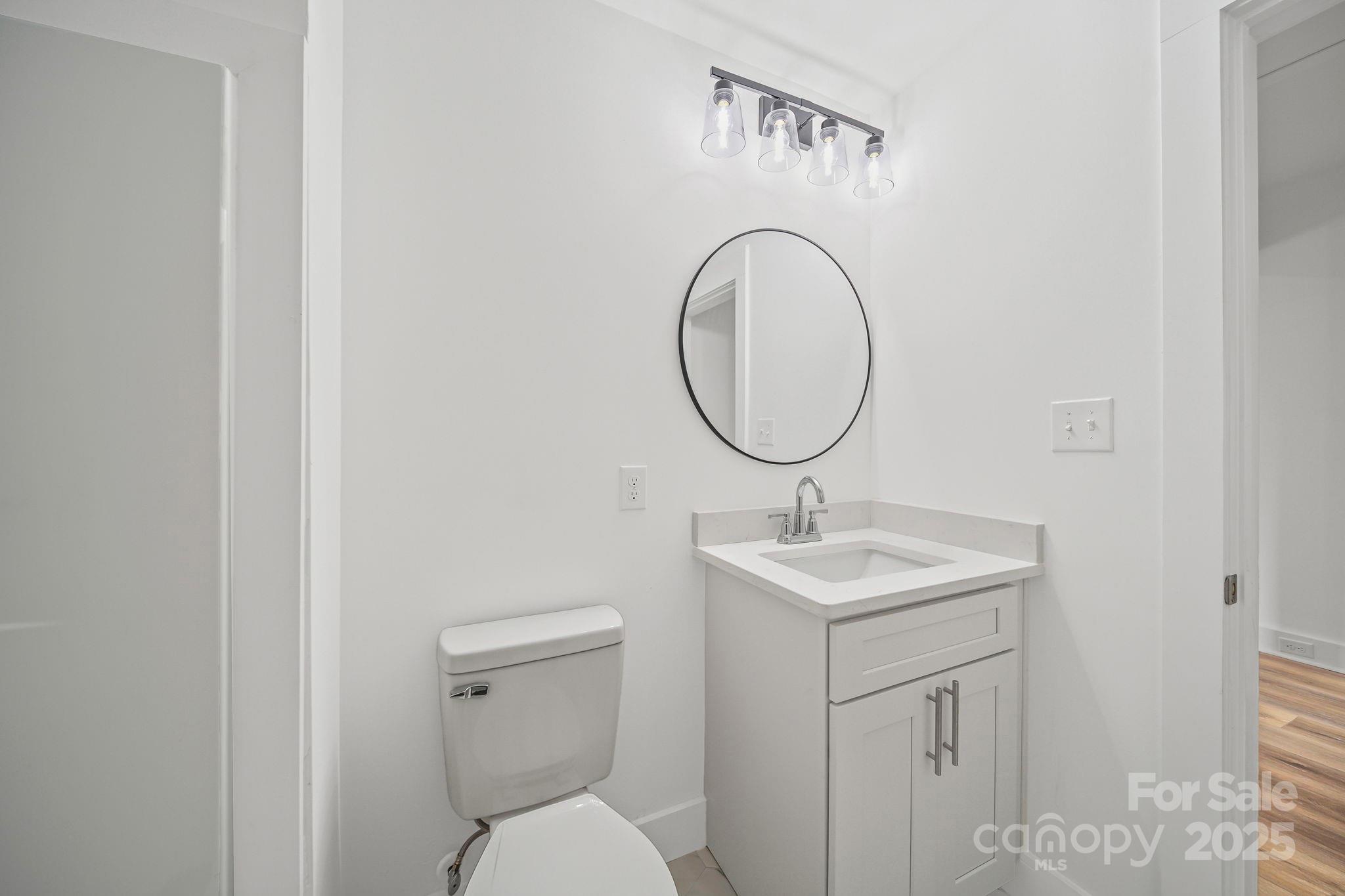 1703 Lowder Street Albemarle, NC 28001 - Photo 23 of 31 a bathroom with a toilet sink and mirror