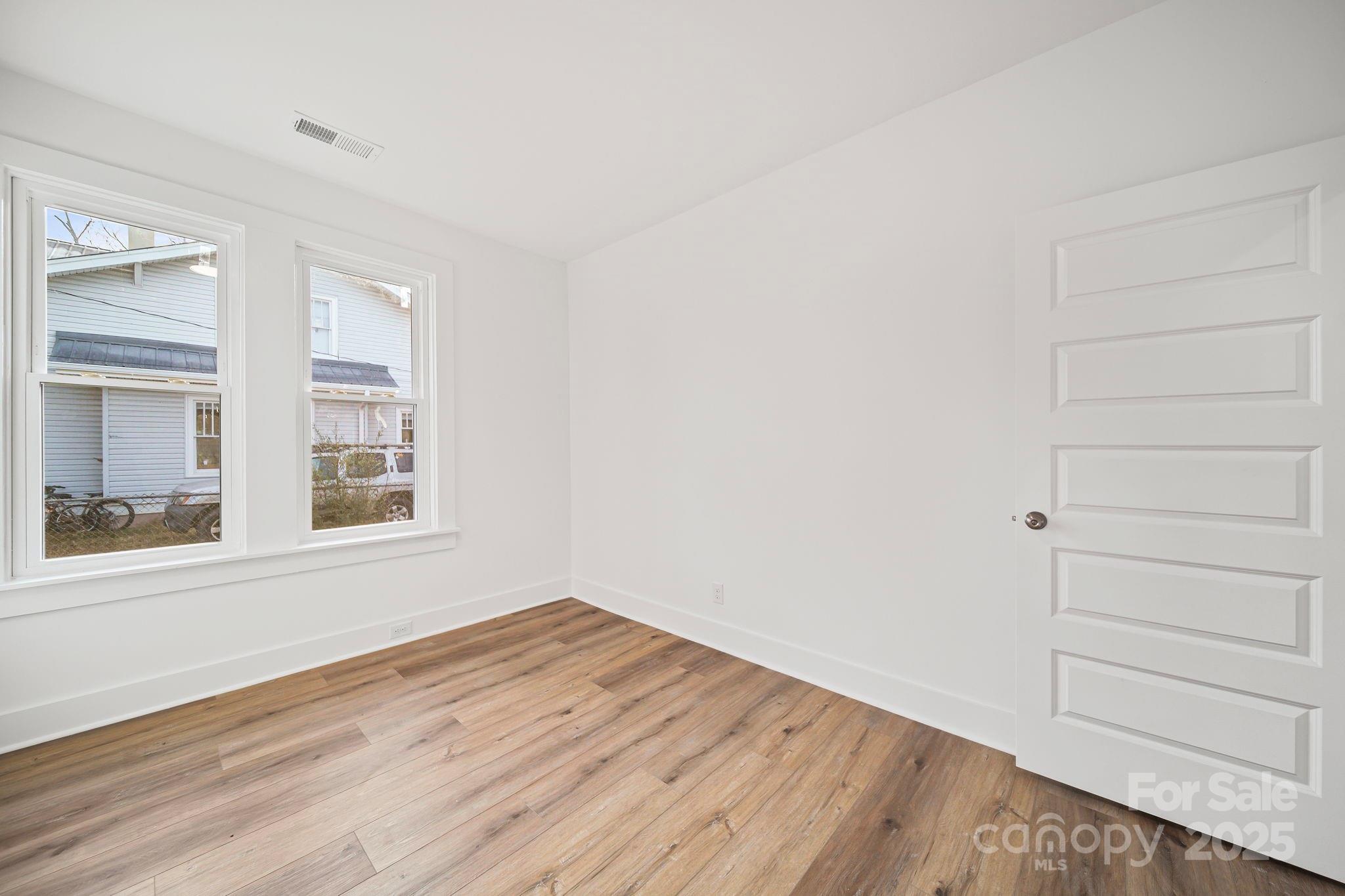 1703 Lowder Street Albemarle, NC 28001 - Photo 25 of 31 a view of empty room with wooden floor and fan