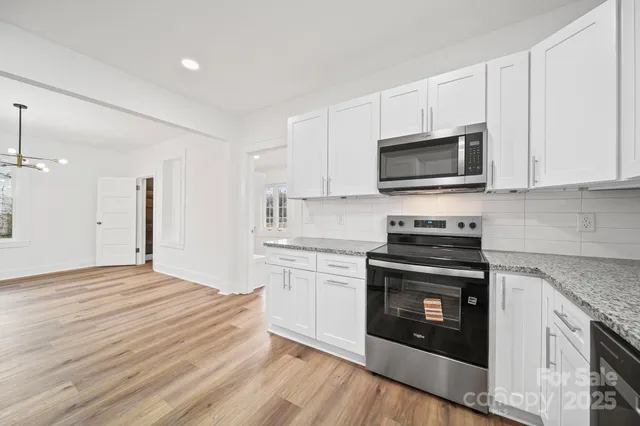 a kitchen with granite countertop a stove top oven and sink