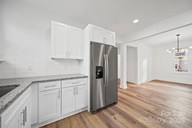 a kitchen with a refrigerator sink and cabinets