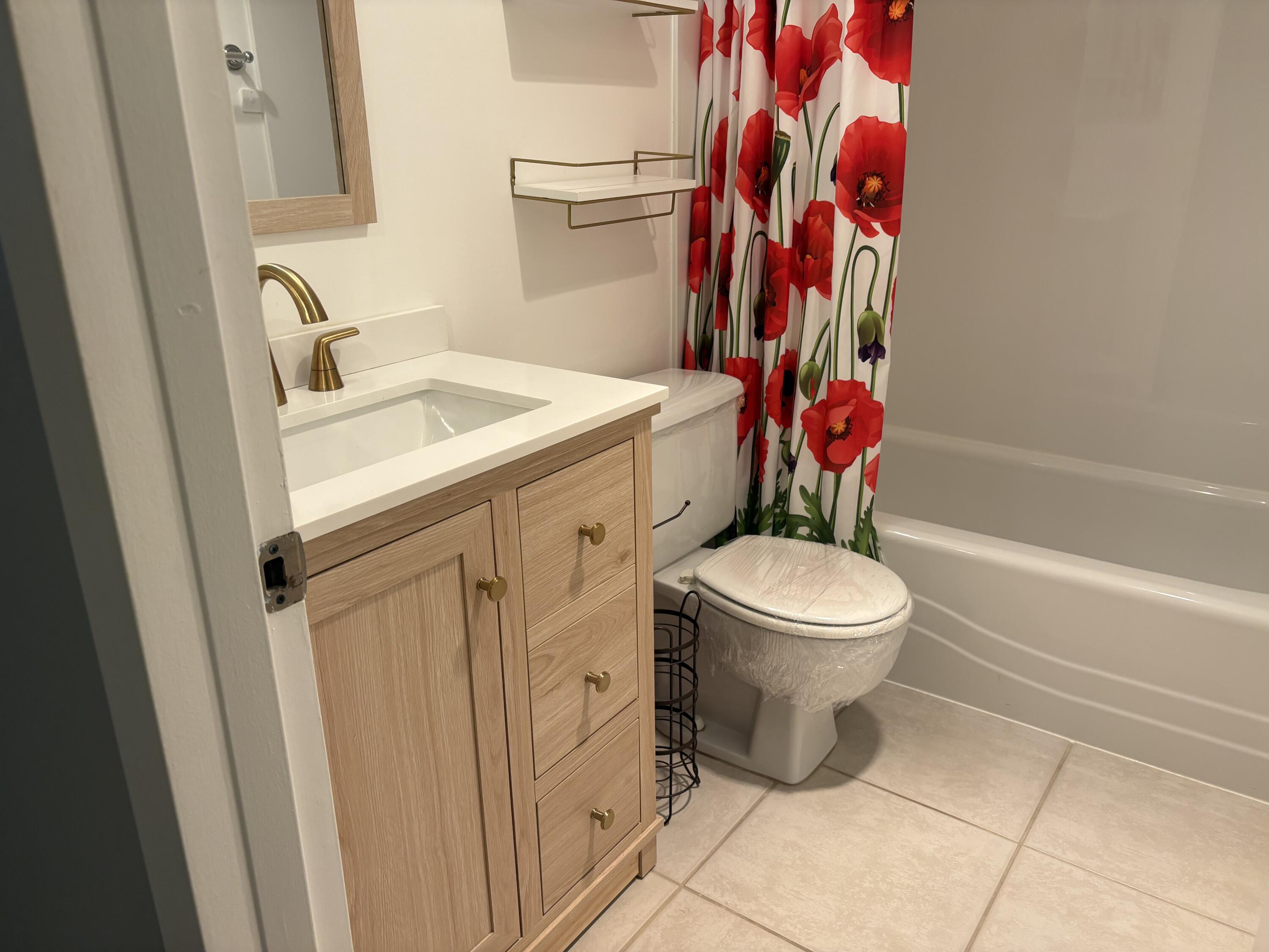124 Dorset C, Unit 124C Boca Raton, FL 33434 - Photo 11 of 21 a bathroom with a toilet and a sink