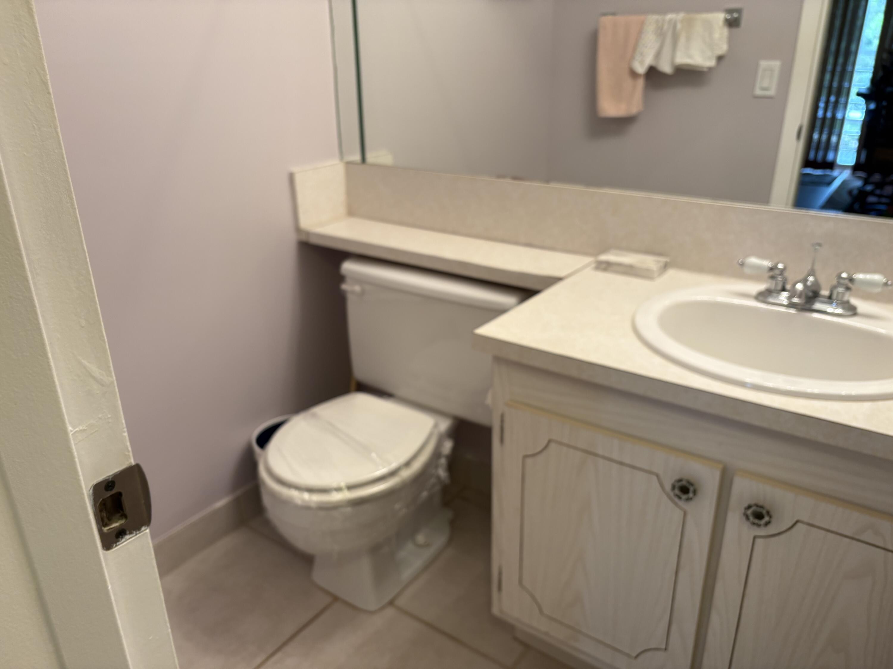 124 Dorset C, Unit 124C Boca Raton, FL 33434 - Photo 13 of 21 a bathroom with a sink and a toilet