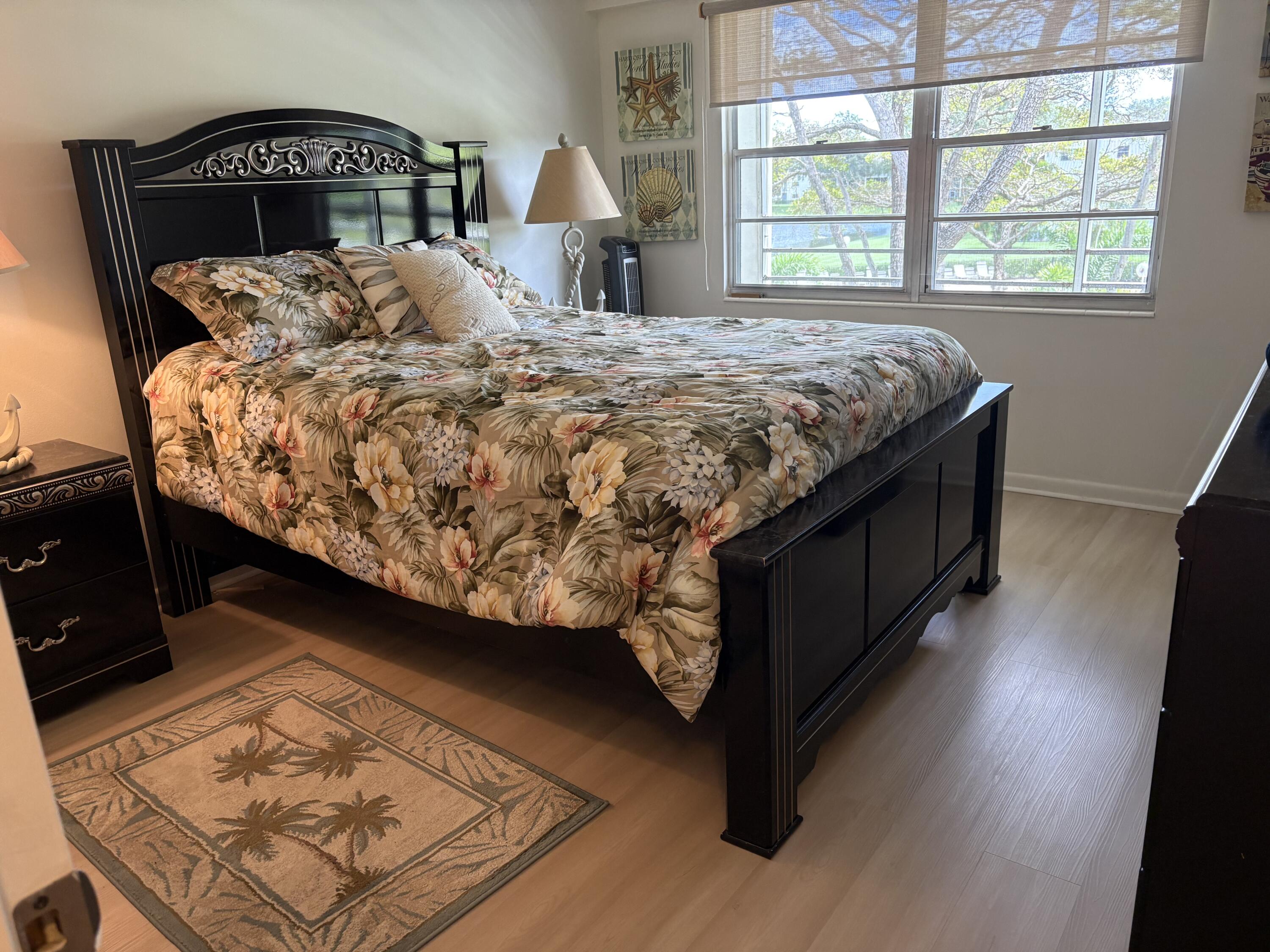 124 Dorset C, Unit 124C Boca Raton, FL 33434 - Photo 15 of 21 a bed sitting in a bedroom next to a window