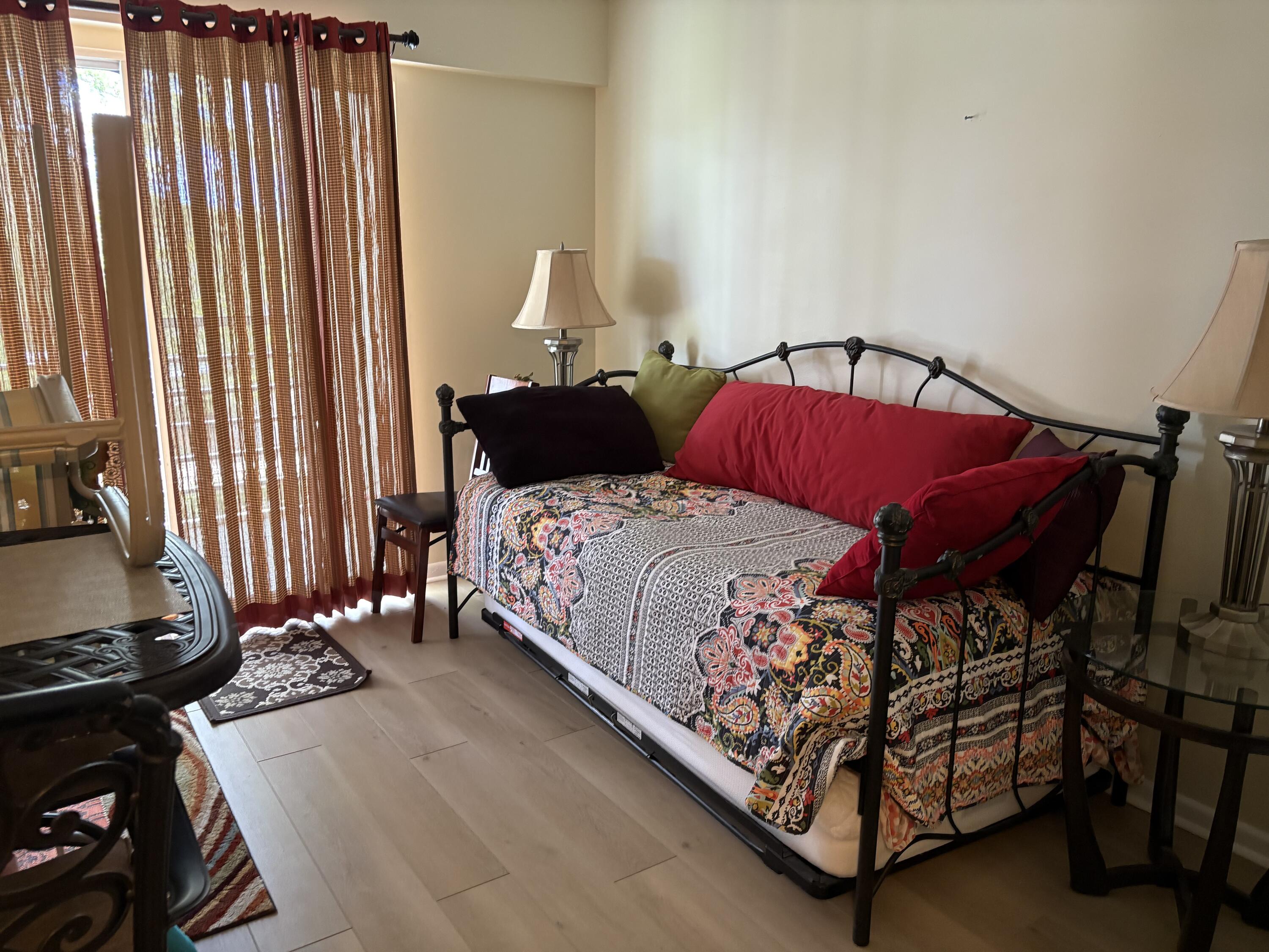 124 Dorset C, Unit 124C Boca Raton, FL 33434 - Photo 16 of 21 a bedroom with a bed and a window