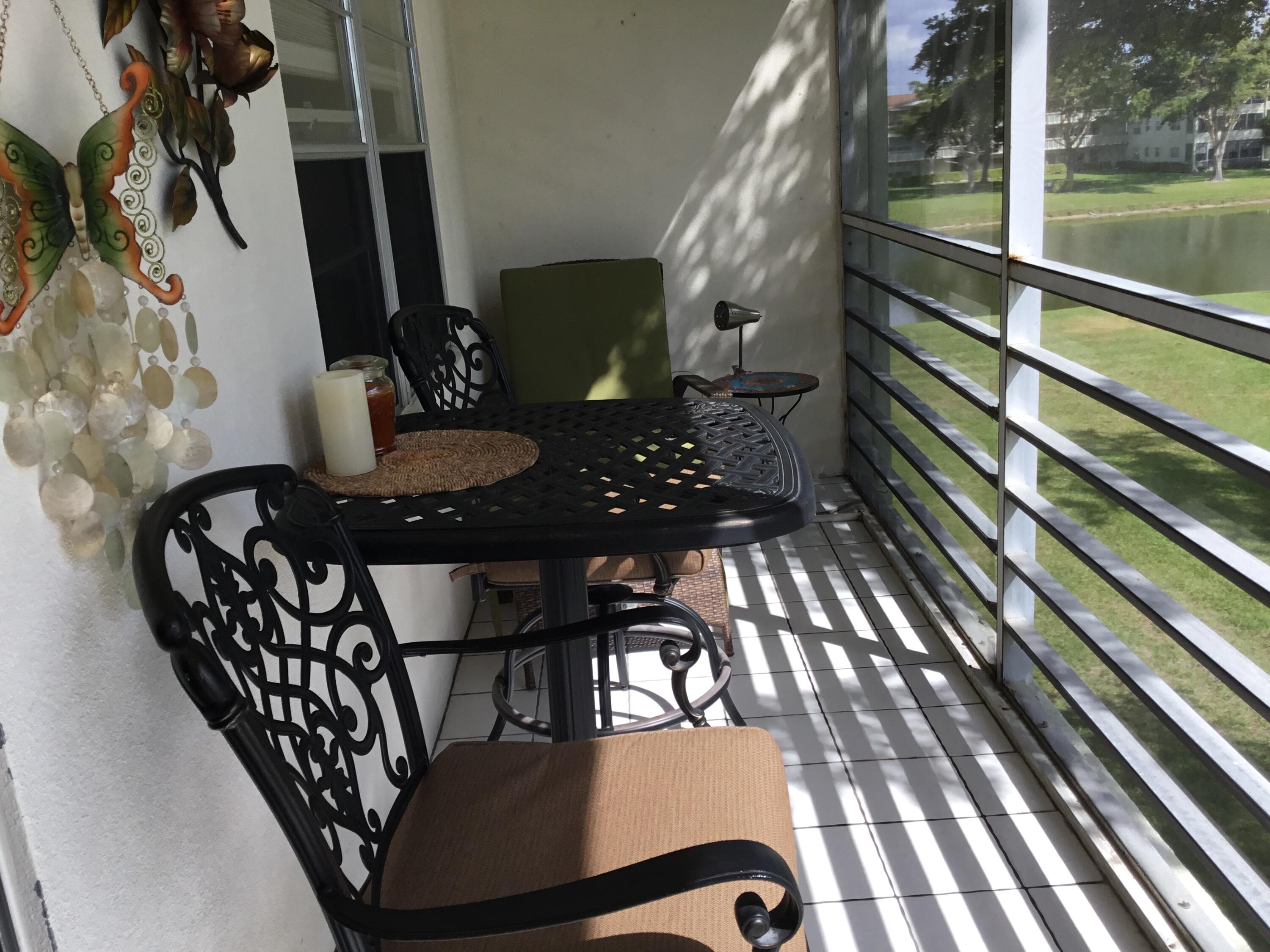 124 Dorset C, Unit 124C Boca Raton, FL 33434 - Photo 18 of 21 a view of balcony with wooden floor