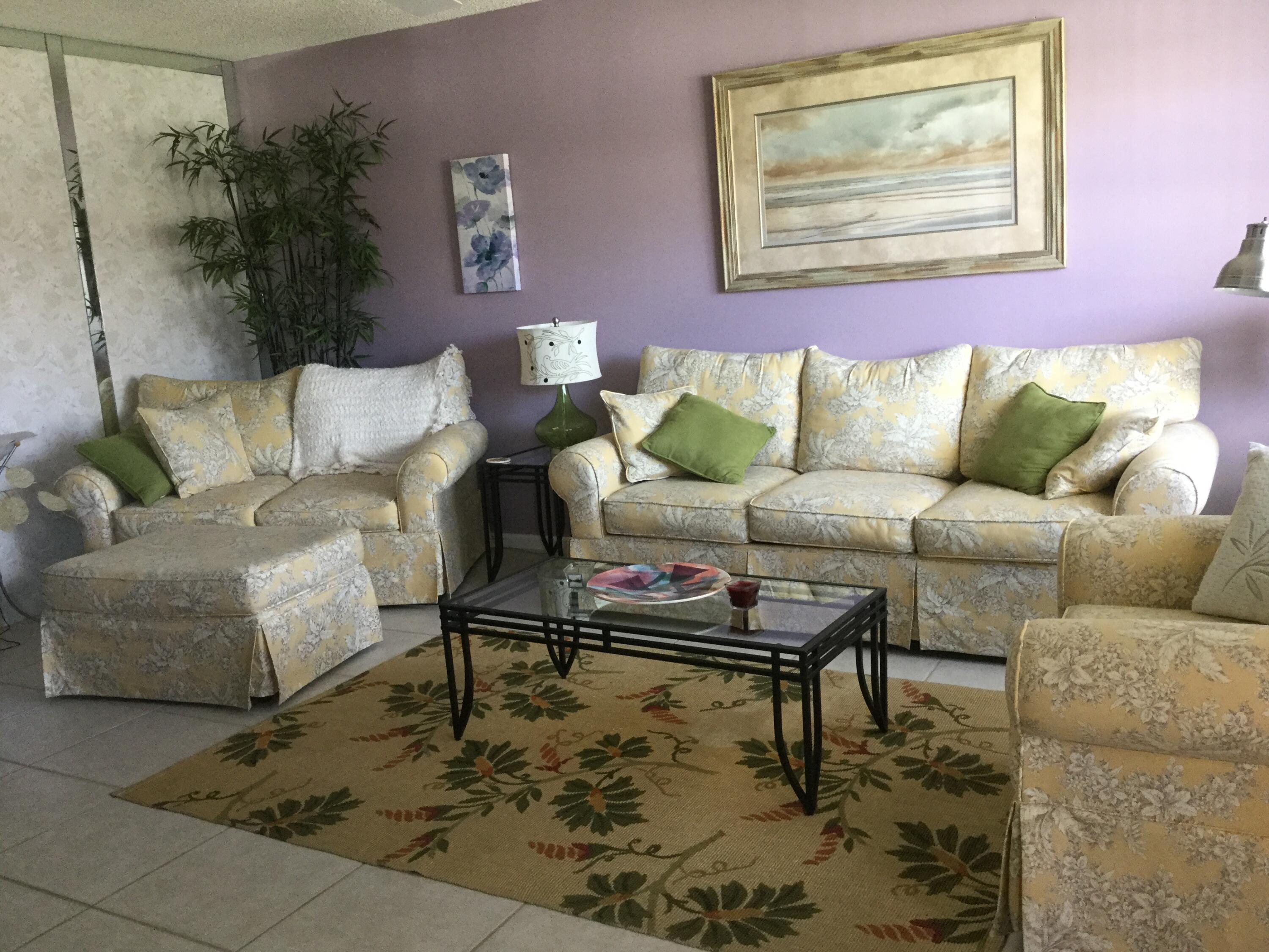 124 Dorset C, Unit 124C Boca Raton, FL 33434 - Photo 6 of 21 a living room with furniture and a rug