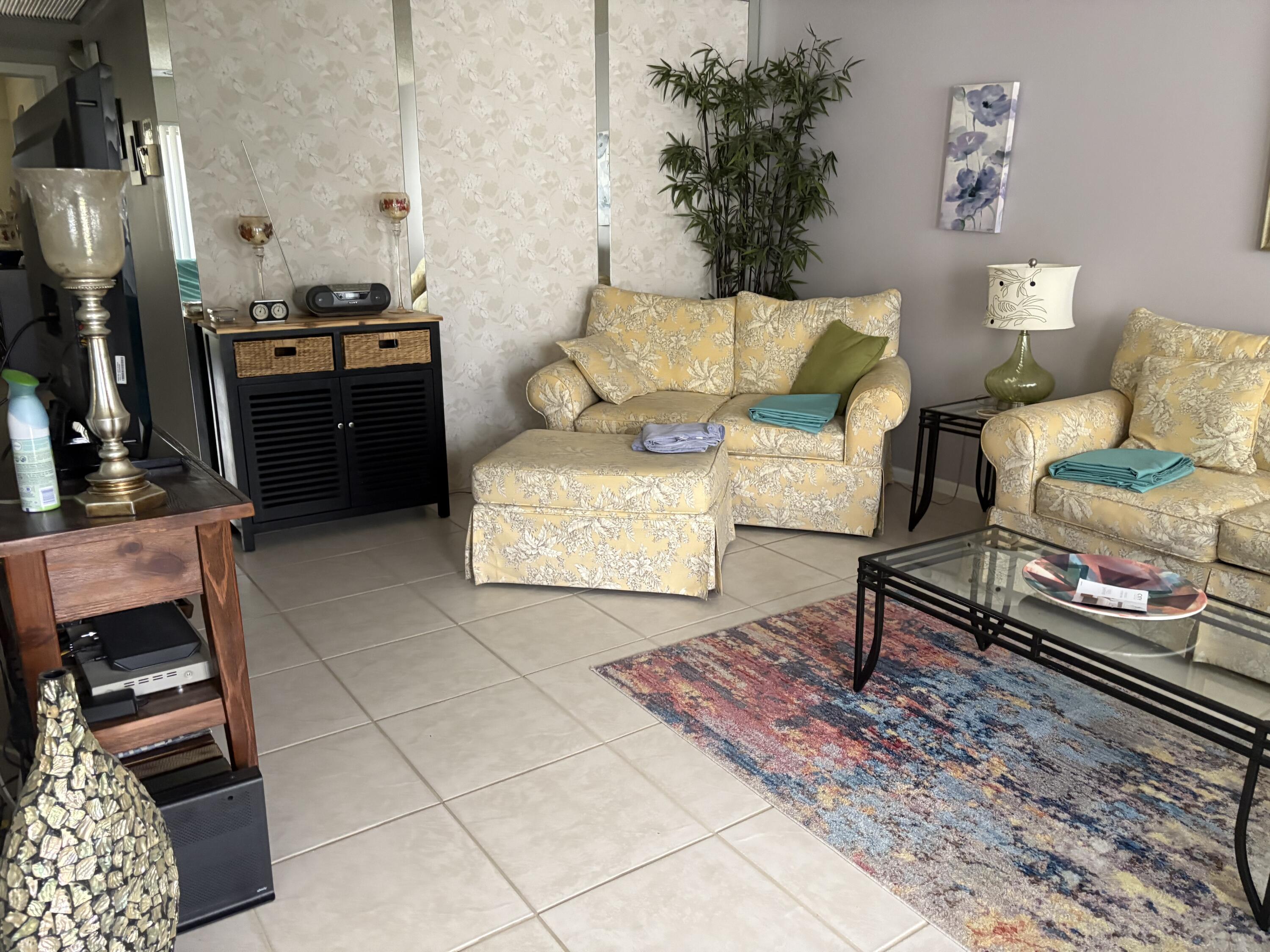 124 Dorset C, Unit 124C Boca Raton, FL 33434 - Photo 9 of 21 a living room with furniture and a fireplace