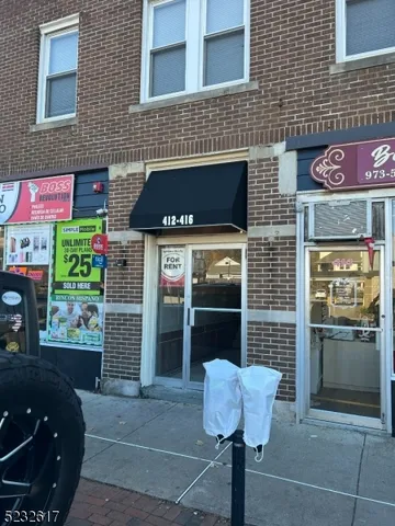 a front view of a house with plants