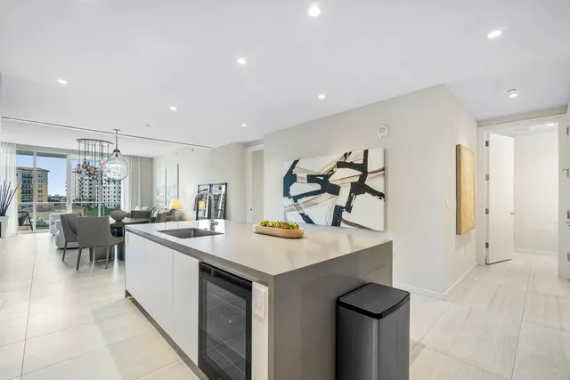 a kitchen with sink cabinets and living room