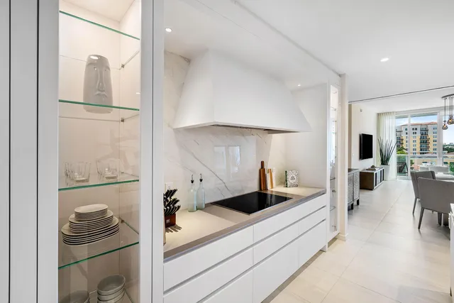 a kitchen with stainless steel appliances kitchen island granite countertop a refrigerator and a stove