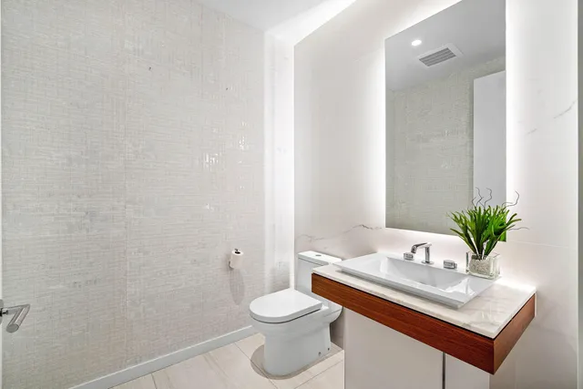 a bathroom with a sink toilet and a mirror