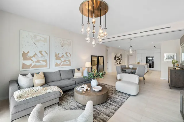 a living room with furniture and a chandelier