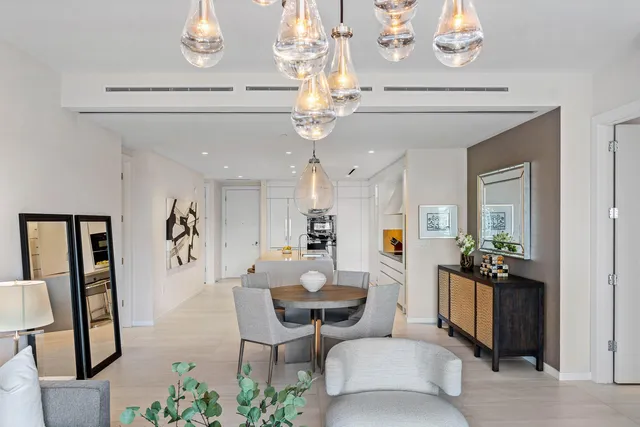 a living room with kitchen island furniture and a chandelier