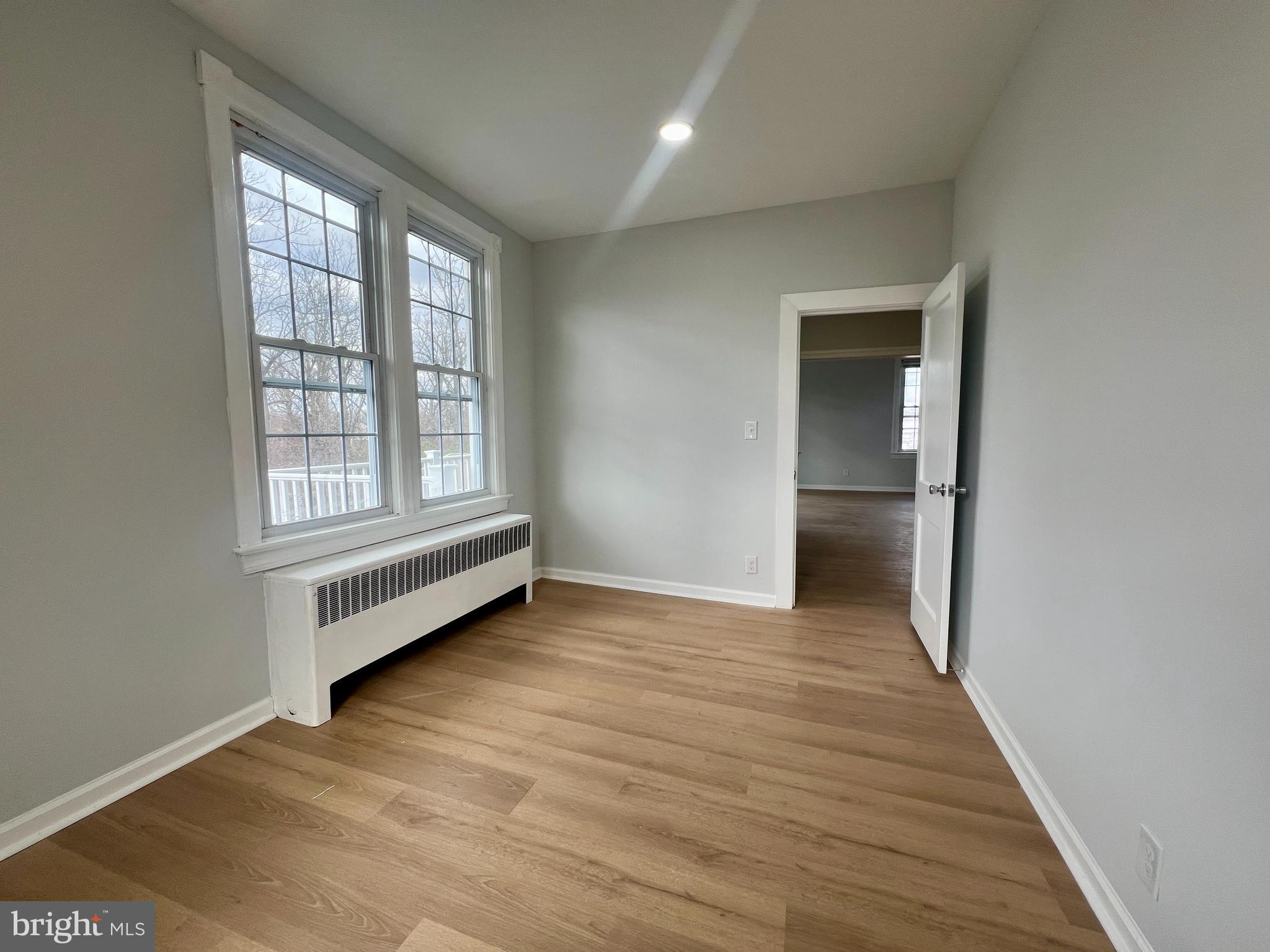 509 Lumberton Road, Unit 2 Hainesport, NJ 08036 - Photo 11 of 13 an empty room with wooden floor and windows