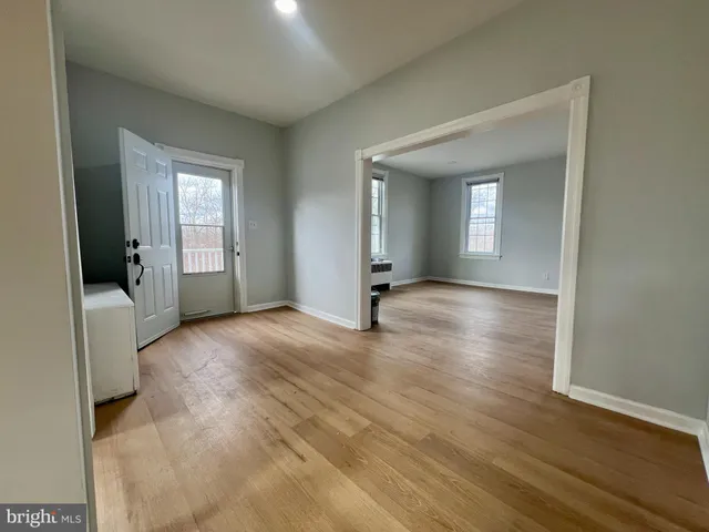 a view of a livingroom with wooden floor and a window