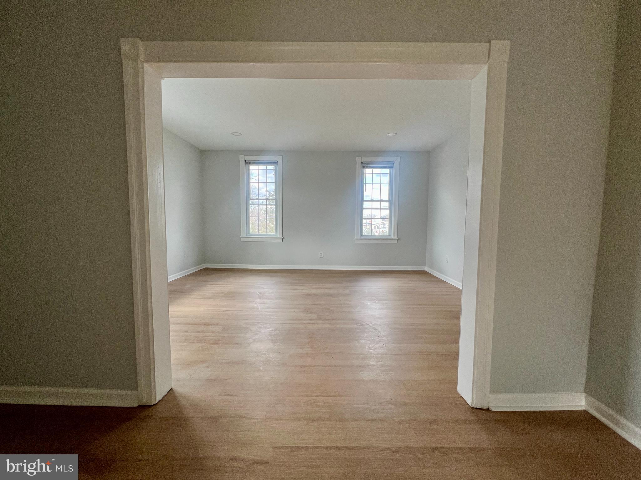 509 Lumberton Road, Unit 2 Hainesport, NJ 08036 - Photo 4 of 13 an empty room with wooden floor and windows