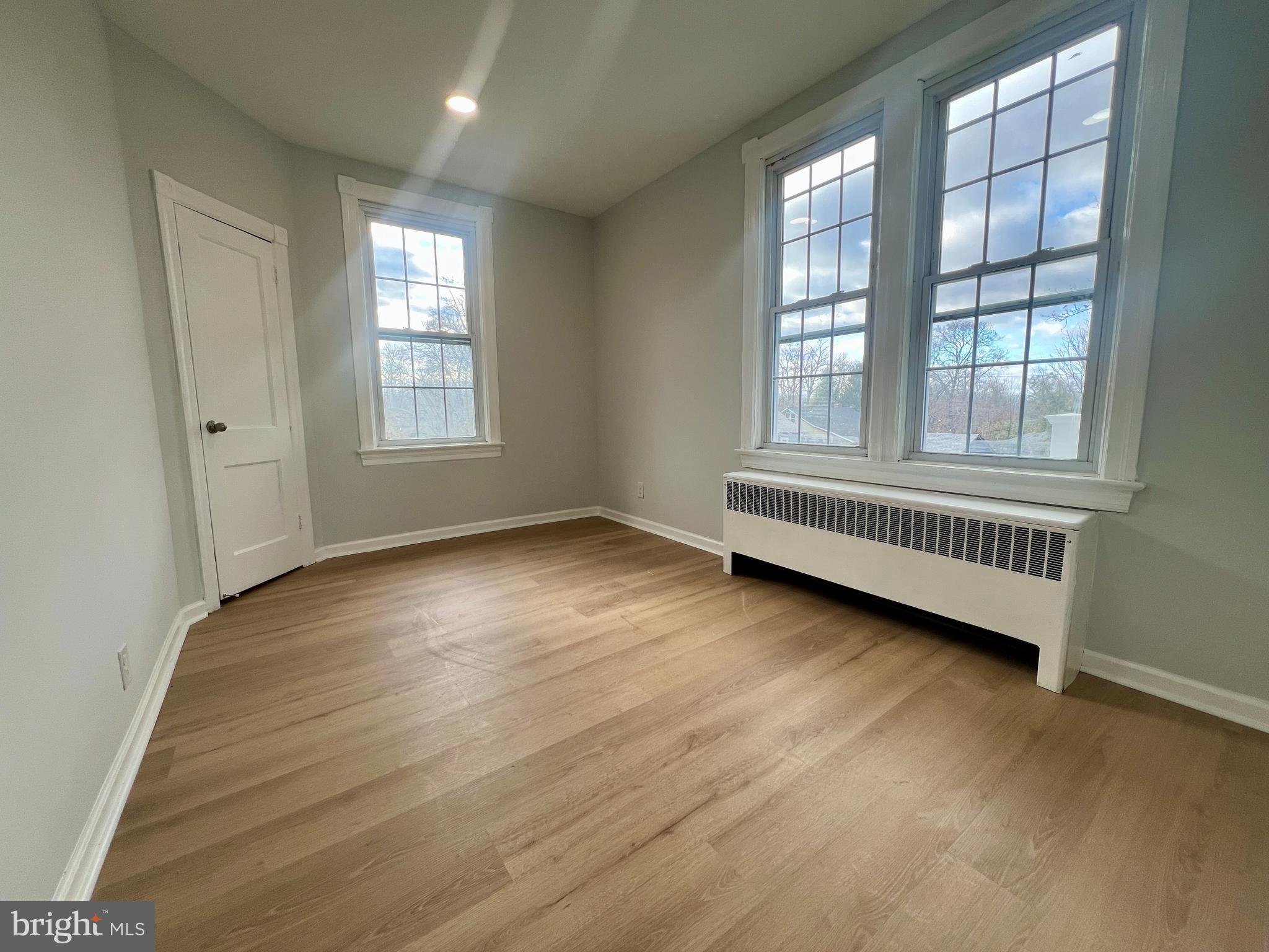 509 Lumberton Road, Unit 2 Hainesport, NJ 08036 - Photo 9 of 13 an empty room with wooden floor and windows