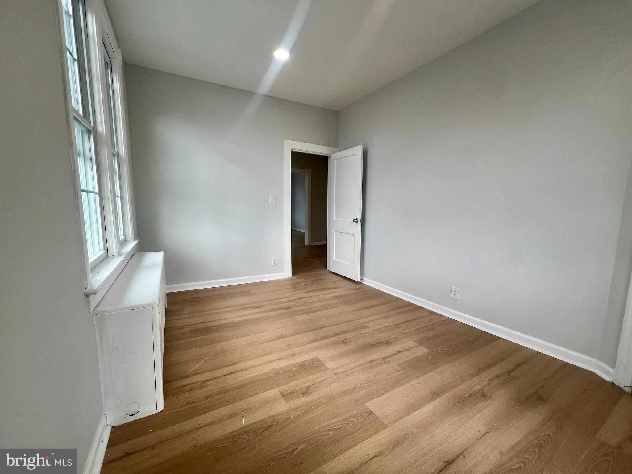 509 Lumberton Road, Unit 2 Hainesport, NJ 08036 - Photo 10 of 13 an empty room with wooden floor and windows