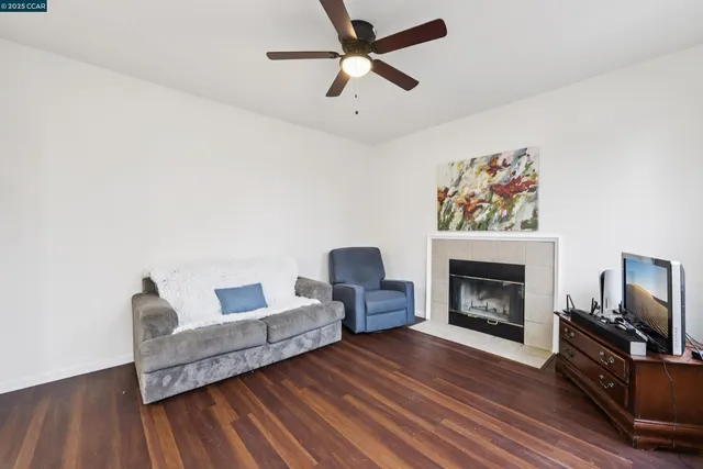 a living room with furniture and a fireplace
