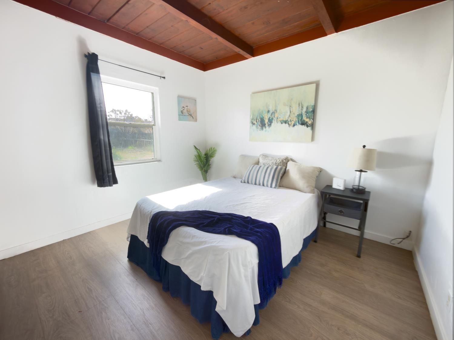 1630 Paradise Road Modesto, CA 95358 - Photo 4 of 42 a spacious bedroom with a bed and wooden floor