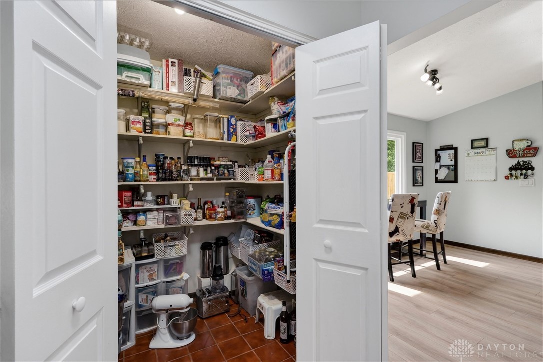 2165 Stewart Road Xenia, OH 45385 - Photo 13 of 59 This spacious pantry provides ample storage with organized shelving, adjacent to an inviting dining area.
