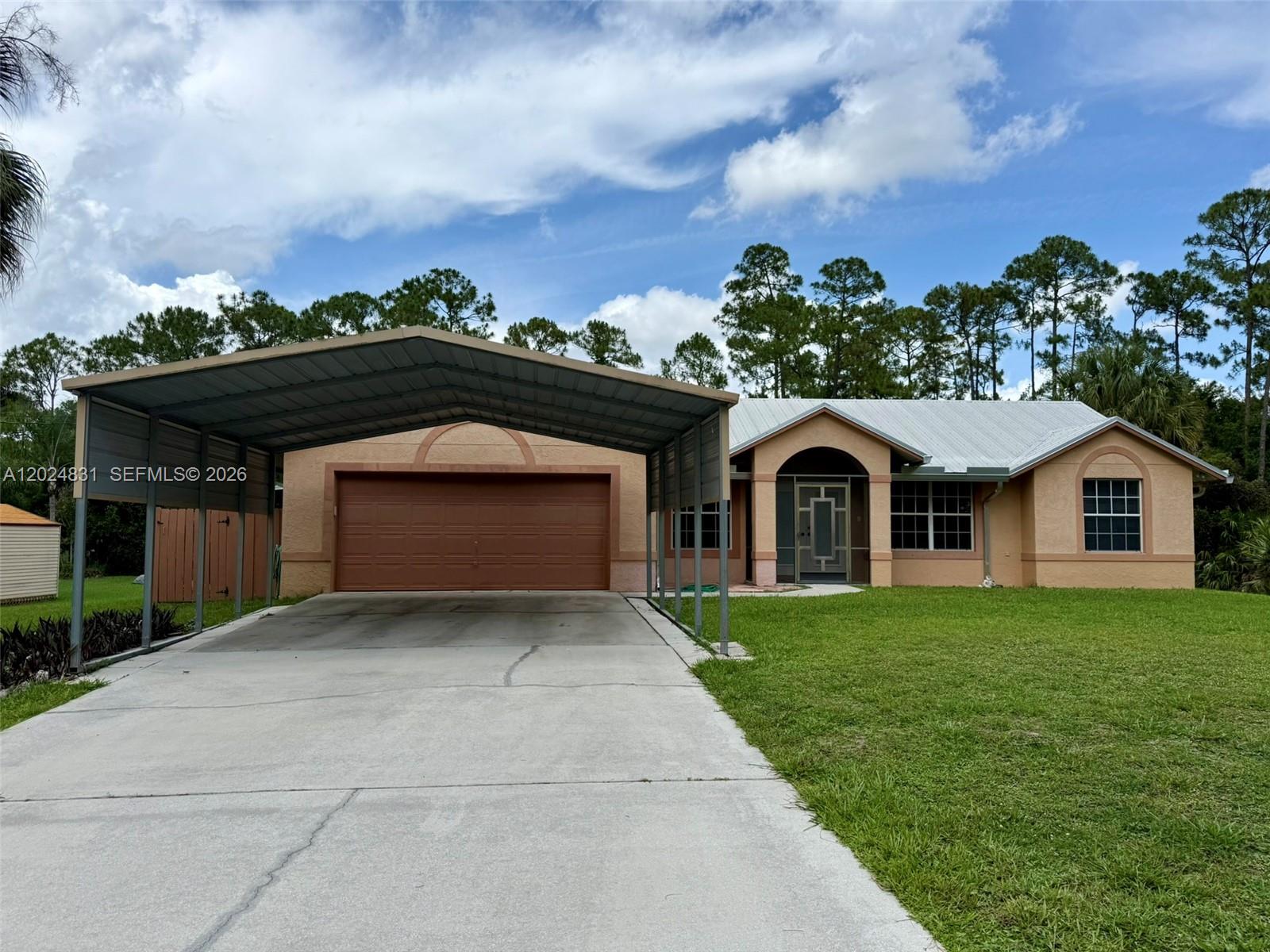 15819 76th Road North Loxahatchee, FL 33470 - Photo 4 of 45 a front view of a house with a yard and garage