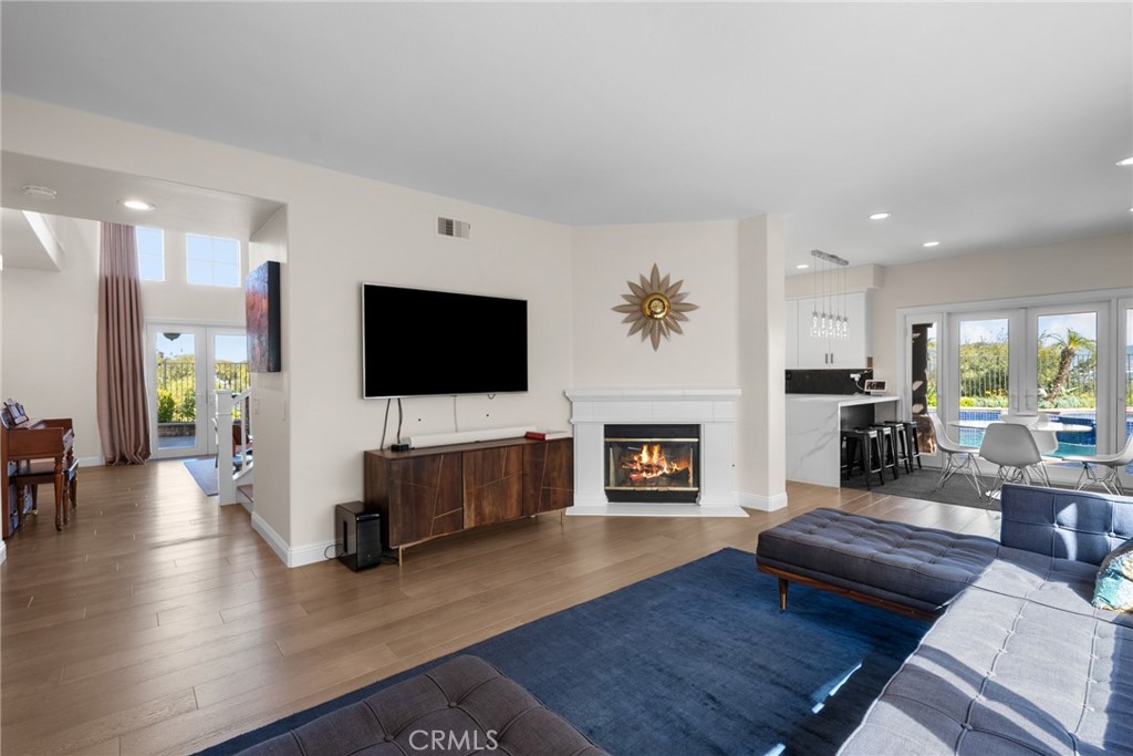 25742 Lewis Way Stevenson Ranch, CA 91381 - Photo 19 of 66 a living room with furniture a flat screen tv and a fireplace