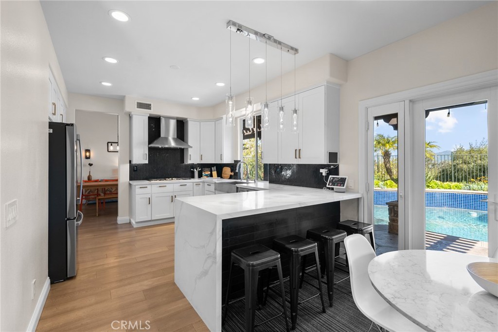 25742 Lewis Way Stevenson Ranch, CA 91381 - Photo 22 of 66 a large kitchen with a table and chairs in it