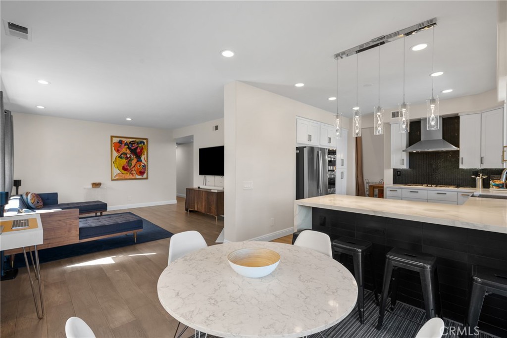25742 Lewis Way Stevenson Ranch, CA 91381 - Photo 23 of 66 a living room with stainless steel appliances kitchen island furniture and a view of kitchen